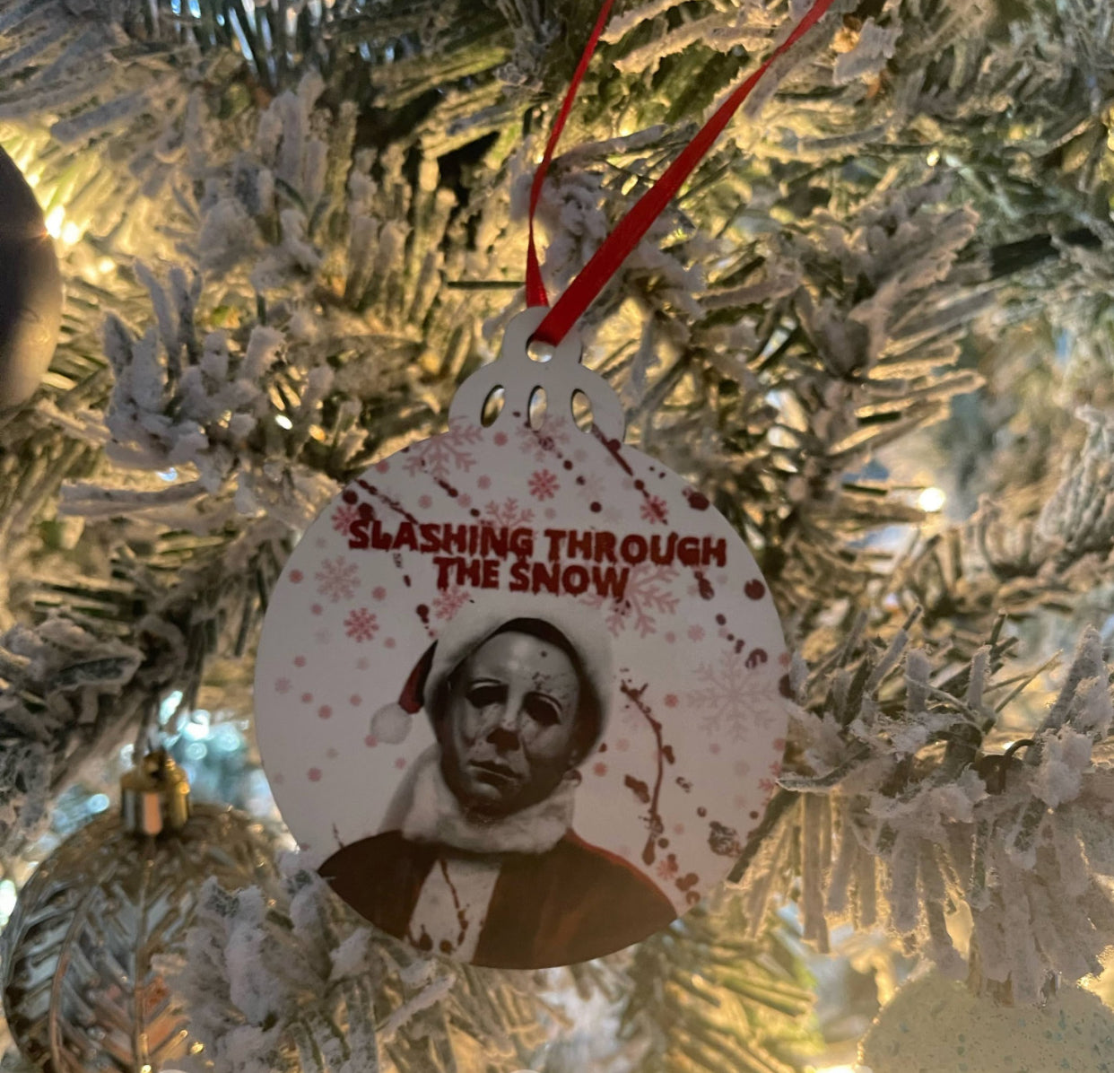 Michael myers slashing through the snow ornament